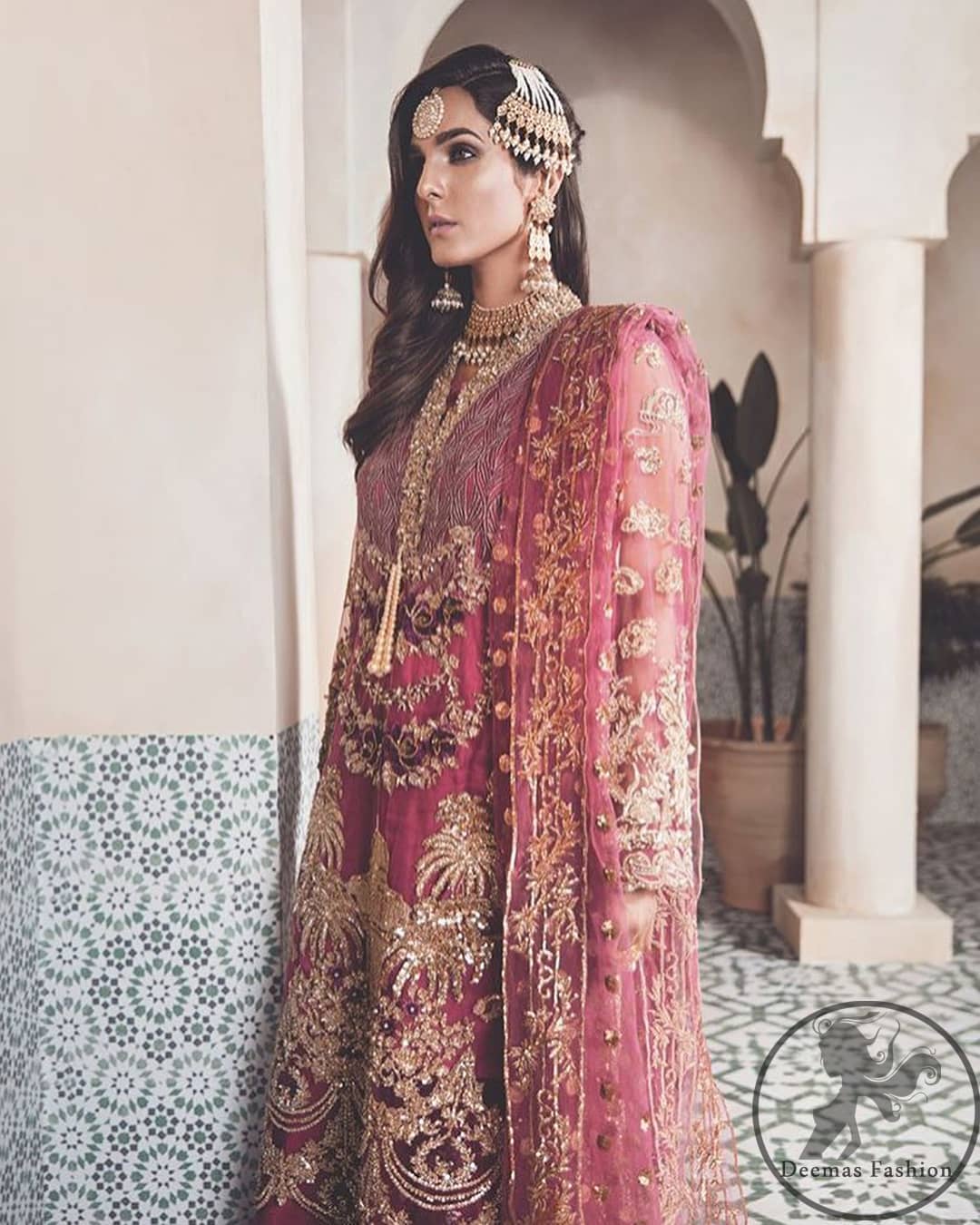 A picture of pure elegance with our net tapestry shirt enhanced with embellished neckline. The daaman is further highlighted with embellished scalloped border. It is paired up with embellished trousers adorned with beautiful motifs. It comes with net dupatta having four sided embroidered border and sprinkled with sequins all over it.