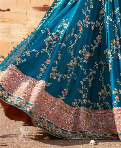 Feel glamorous in our venice blue blouse skirt with fascinating embellishment on neckline with silver kora dabka, pearl and sequins.