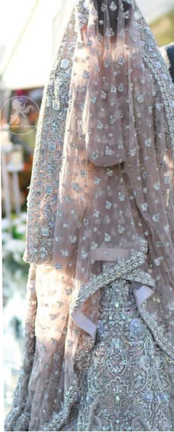 The grand gold bridal stands out due to its uniqueness and the perfect fusion of modern cut and traditional embroidery. This dress is beautifully decorated with heavy embroidery. It is highlighted with kora, dabka, tilla, sequins and pearls. Style it up with embellished wait belt. It comes with brocade pajama. It is coordinated with tissue dupatta which is sprinkled with sequins all over it. It is further furnished with four sided thick embellished border.