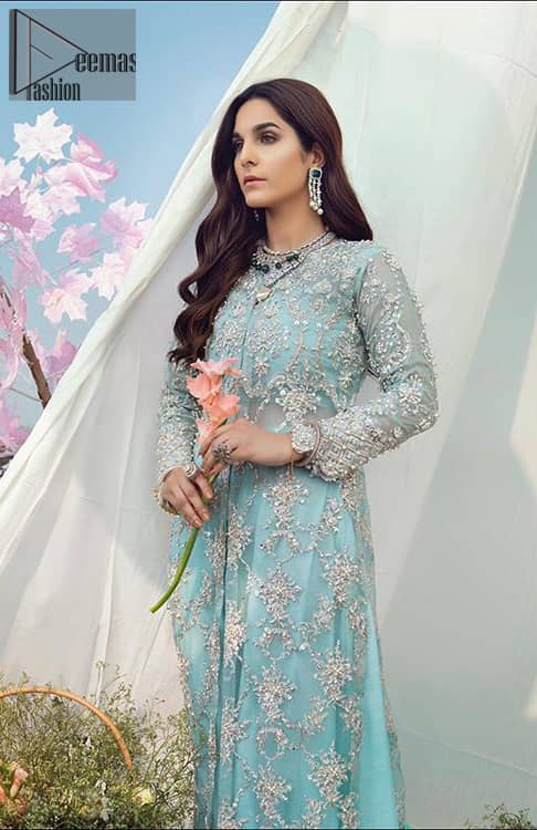 The perfect combination of tradition and class for your walima. This heavenly handcrafted front open style bridal showcases the traditional art of zardozi, nakshi, kora, dabka, sequins and beads, adorning the intricate and meticulous hand embellishments giving it a wholesome gentle stance paired with sharara. The bottom of the shirt is enhanced with thick scalloped border and finishing with tassels. Having full length sleeves adorned with sequins and and embellished floral bootis. The outfit is beautifully coordinated with matching dupatta with scalloped borders on all sides and sequins spray all over.