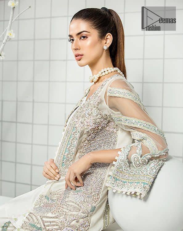 This formal wear dress is majestic beauty. Delicately crafted and personifying chic elegance with an element of grandiose. A full heavily embroidered front open shirt with silver zerdozi work details all over. The daaman is furthermore highlighted with embellished border. Having full length sleeves adorned with silver kora, dabka and tilla embroidery. Paired up with organza straight trouser decorated with embroidered lace. It comprises with chiffon dupatta having sprinkled sequins on the ground.