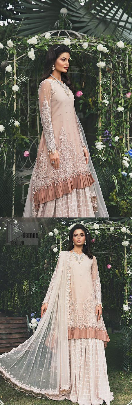 Go for this trendy dress which is perfect for your nikah. Feel glamorous in our ivory a-line frock with fascinating embellishment on neckline with silver kora, dabka, pearl and sequins. The daman is emphasized with detailed matching embellishment and finished with choclate brown frill. It comprises with sharara adorned with criss cross pattern. This outfit is paired up with net dupatta focusing on kora and dabka handwork borders on all four sides, sequins spray all over and finished with tassels.