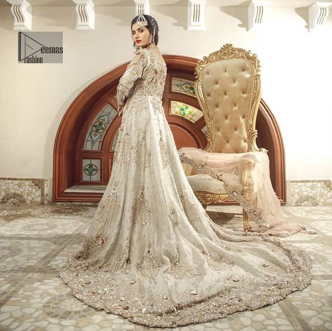 Bring out your beauty with this back trail maxi perfect for your big day. This bridal dress is beautifully sculptured with floral embroidery, adorned with cutwork borders embellished with silver kora, dabka, pearl and sequins work all over. The detailed resham and tilla work on the back of maxi and multiple floral motifs ornamented with gold kora and dabka embroidery on the bodice, the thick borders and floral bunches refined the classical royal look. Furthermore full length sleeves heavily embellished with zardosi work. It comprises with churidar pajama.