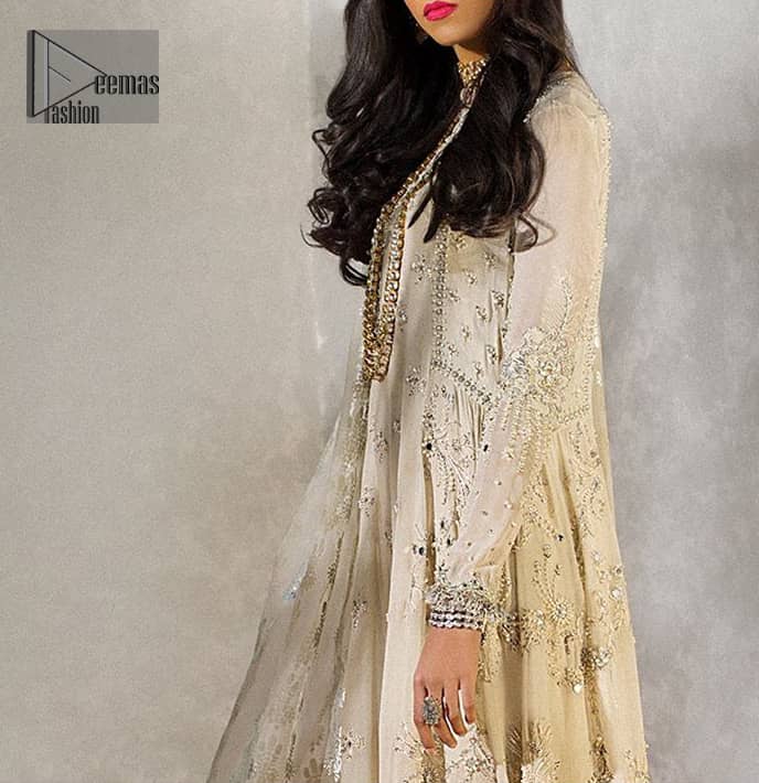 Reflecting royalty and the majestic beauty of statuesque shape and silhouette which makes the dress perfect for nikah day. This regal ivory a-line shirt is an immensely captivating traditional piece. Having full length sleeves adorned with a large floral motif in the center. The daman is furthermore highlighted with matching embellishment that instantly draws attention. It comprises with cigarette pants. Pair it up with self embroidered tissue dupatta.