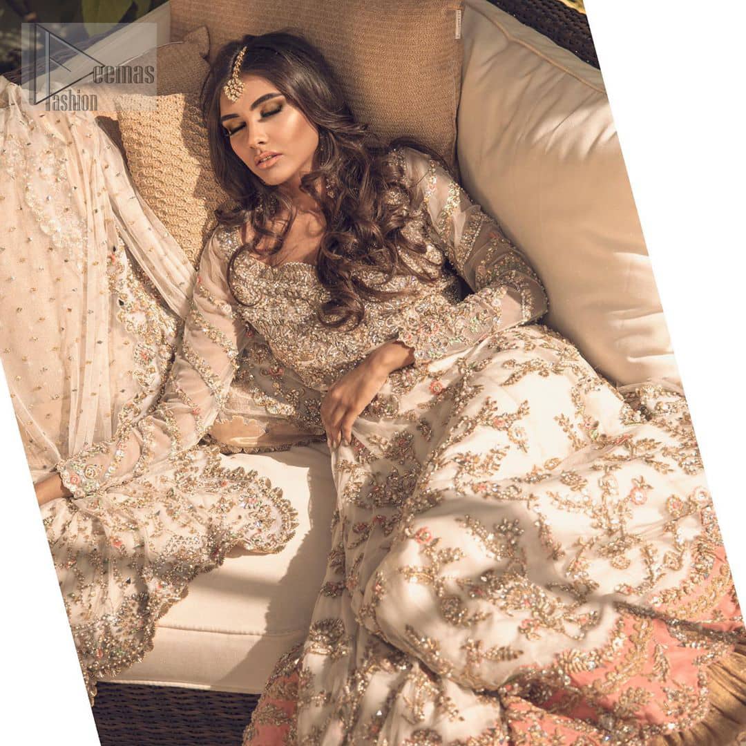 Reflecting exuberant color play in this ethereal piece meticulously highlighted with antique shaded kora, dabka, tilla and sequins. The frock is delicately crafted with floral bunches, fully embellished bodice and scalloped applique daman to give it a perfect ending. The contemporary yet traditional embroidered stripes on the sleeves completes the look. The outfit is comprises with mustard crushed sharara. It is paired with ivory chiffon dupatta with sequins chann all over and two sided embroiderd pallu.