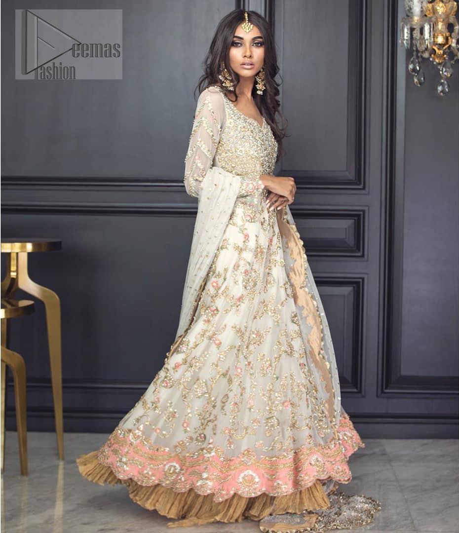 Reflecting exuberant color play in this ethereal piece meticulously highlighted with antique shaded kora, dabka, tilla and sequins. The frock is delicately crafted with floral bunches, fully embellished bodice and scalloped applique daman to give it a perfect ending. The contemporary yet traditional embroidered stripes on the sleeves completes the look. The outfit is comprises with mustard crushed sharara. It is paired with ivory chiffon dupatta with sequins chann all over and two sided embroiderd pallu.