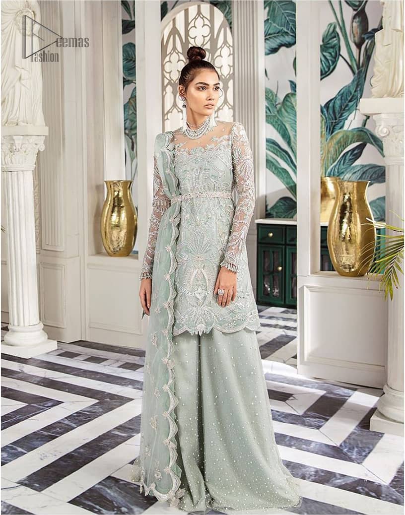 Delicately crafted and personifying chic elegance with an element of grandiose. This outfit is aesthetically designed with motifs and floral patterns, embellished with kora, dabka, nakshi, sequins, cutdana and crystals. The detailed scalp border gives a perfect ending to this peplum. Beautifully designed sleeves is an amalgamation of floral design elements. Sharara comprises of sequins spray all over. The dupatta incorporates beautifully designed scalloped borders on all four sides and tiny floral motifs.