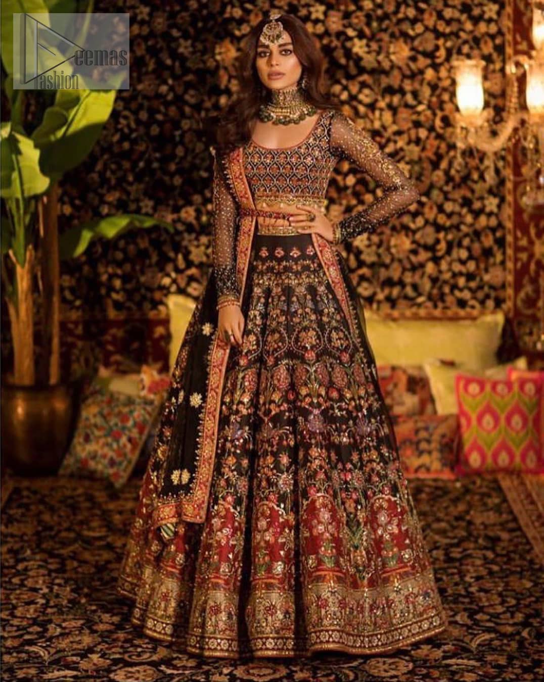 Tradition meets modernity. Go glam in our black traditional lehenga blouse. This outfit bursts of vibrant colors and sumptuous details of zardozi, gota, kora and dabka is a perfect Mehndi ensemble. It is aesthetically designed with thick borders and floral bunches refined the classical royal look. Blouse is decorated with geometric patterns having full sleeves adorned with zardosi work and sprinkled sequins. Style it up with black net dupatta sprinkled with tiny floral motifs and four sided applique embellishment. The piece comes with a handcrafted belt.