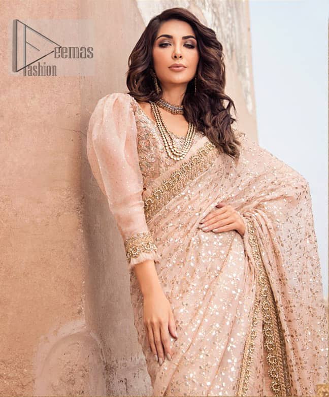 Steal the show with this endearing chiffon saree with intricate yet rich mukesh details. Crafted artfully with detailed thread embroidery on saree pallu and traditional neckline finessed with kora, dabka and kundan. Having full sleeves with mukesh details and zardosi finishing. Furthermore it is adorned from all sides with antique shaded kora, dabka, tilla and sequins.