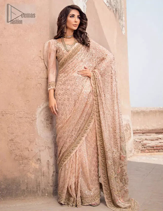 Steal the show with this endearing chiffon saree with intricate yet rich mukesh details. Crafted artfully with detailed thread embroidery on saree pallu and traditional neckline finessed with kora, dabka and kundan. Having full sleeves with mukesh details and zardosi finishing. Furthermore it is adorned from all sides with antique shaded kora, dabka, tilla and sequins.