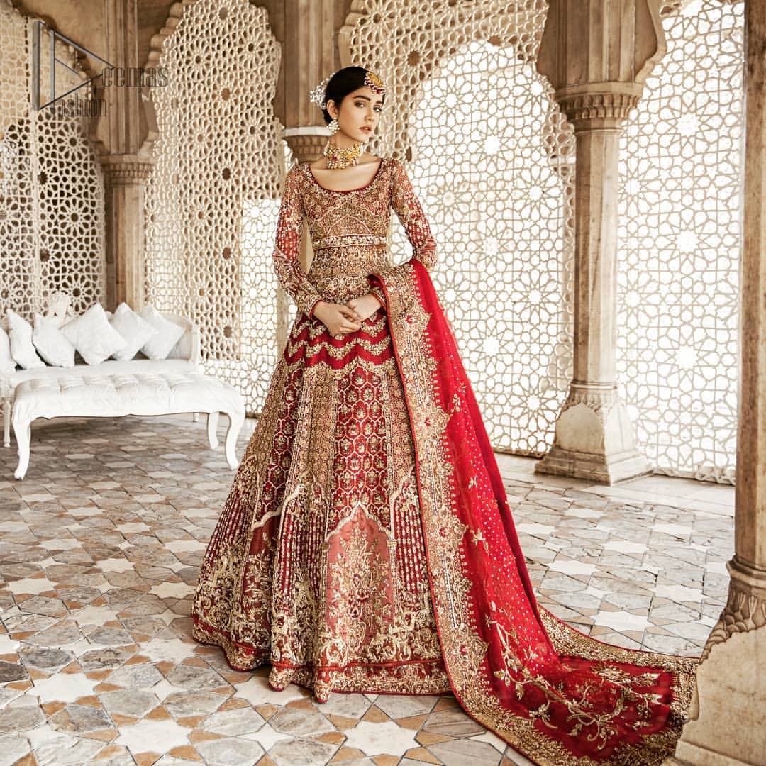 Captured in traditional silhouette, This traditional red pishwas is aesthetically designed with motifs,geometric and floral patterns, embellished with kora, dabka, tilla and sequins work. It comes with full embellished lehenga which is gorgeously handcrafted with golden and antique shaded zardozi work. The piece comes with a handcrafted belt. It is coordinated with net dupatta which is sprinkled with sequins all over it. It is further furnished with four sided border and floral bunches.