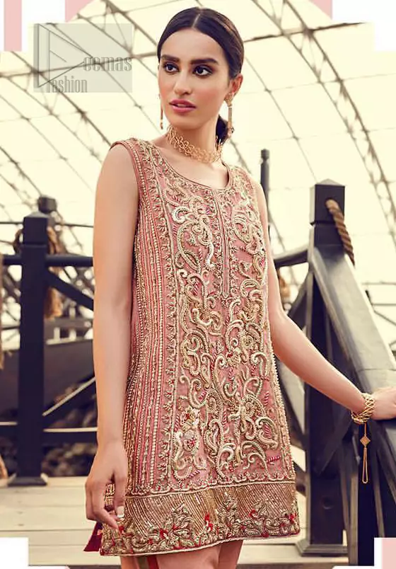 Delicately crafted and personifying chic elegance with an element of grandiose. You are all set to make a lasting impact with the divine royalty of this dress. The outfit is perfected with loaded dull golden, golden and antique work. The shirt is delicately hand crafted using the finest old age techniques and materials including kora, dabka, tilla, sequins and pearls. The back of the shirt is highlighted with cutwork embellishment. Furthermore it is also enhanced with thread embroidery. This outfit is comprises with peach raw silk bell bottom. Complete the look with peach organza dupatta decorated with sequins spray all over.