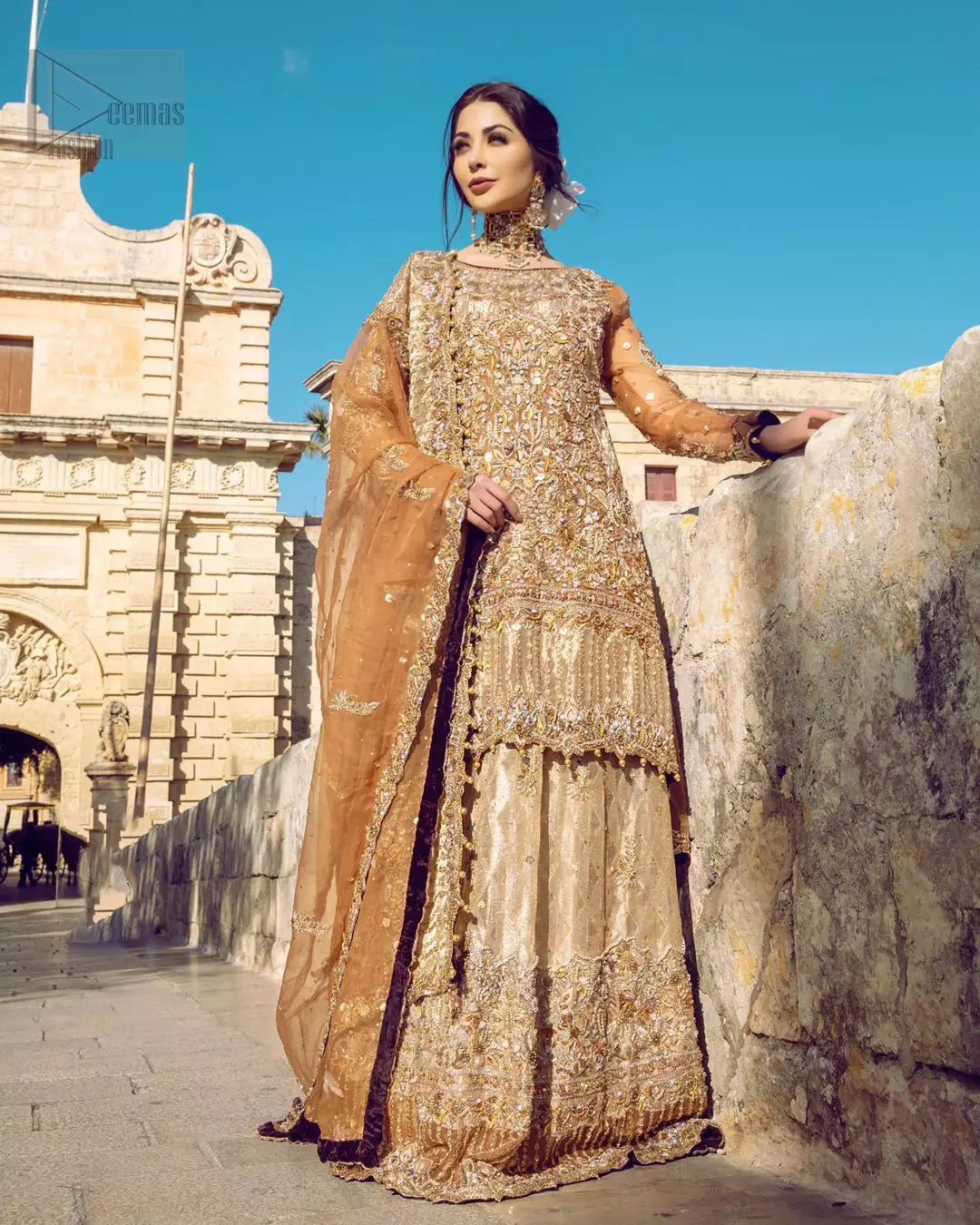 Dazzle in this made to perfection, richly embroidered ensemble accentuated with floral motifs and finished with scalp borders. Excellence of craftsmanship is evident with intricate detailing that features the use of kora, dabka, crystals, sequins and pearls. The Scalloped hemline is emphasided with dangling pearls. Balance the look with light golden lehenga adorned with golden, silver and antique shaded zardozi work. Dupatta comes with embellished alluring cut work floral border gives the perfect ending to this peplum.
