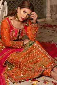 Get bold and beautiful with this uber-stylish ensemble that has flattering cuts, and a colour palette that is bewitching. This orange long shirt adorned with intricate tilla work, kora, dabka and sequins is perfect ensemble for mehndi. Furthermore the shirt is also highlighted with pink embellished bodice and rest of the shirt is enhanced with geometric gota embroidery and green applique instantly draws attention. It comprises with orange pajama adorned with gota work. Paired with pink chiffon dupatta with kiran lace finishing all around the edges that gives the right amount of glamour to the outfit.