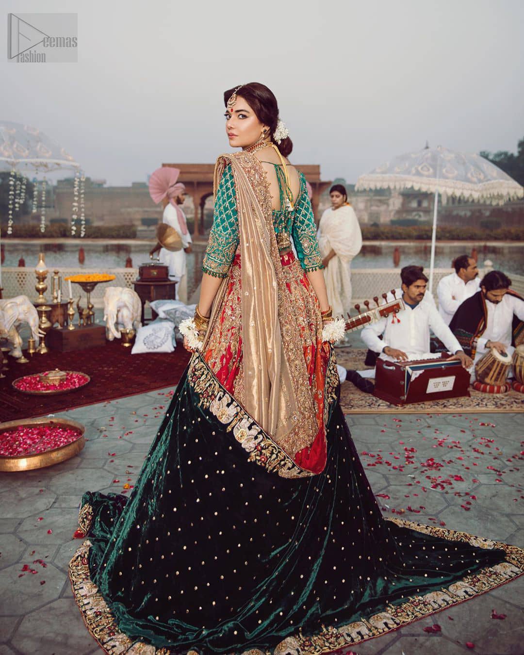 Classic, timeless and truly beautiful, our bridal dress is perfect for your unforgettable day. Excellence of craftsmanship is evident with intricate detailing that features the use of zardozi work. The blouse is beautifully adorned with geometric patterns and floral embroidery with golden zardozi work and finished with dangling beads. Complete the look with artfully coordinated lehenga which is ornamented with a bold and captivating design with a traditional intricate embroidery and scattered tiny floral motifs. The combination of red and orange for lehenga is also captivating. Elegance is personified when it gets paired up with golden dupatta having four sided embroidered border.