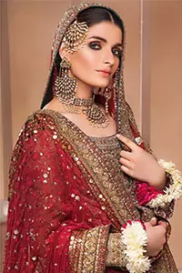 This style-savvy bride totally pulled off our classic bridal wear with an unmatchable grace and giving major bridal goals. The lehenga colour is the perfect feminine and delicate shade with its meticulously crafted fabrication with geometrically embellished border filled with gorgeous tiny floral motifs in it. The shirt is beautifully ornamented with geometrically arranged motifs and intricate details at the bottom. The zardozi embroidery is done in the shade of tan. Pair it up with maroon organza dupatta adorned with sterling sequences and four-sided embellished borders to give it a regal look.