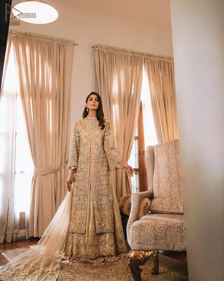 An unforgettable look and ideal for the festive season. An elegant yet trendy front open style makes this outfit more classy. Crafted artfully with detailed zardozi work and illusion neckline finessed with kora, dabka, and Kundan. The motifs and intricate details are a true example of decorative and ornamental expression stylized in a contemporary way. The bell sleeves make this outfit more classy. Balance the look with banarsi lehenga highlighted with embroidered borders at the bottom. The dupatta is enhanced with embroidered pallu.
