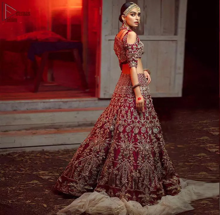 Maroon Pakistani bridal wear half blouse and lehenga comes with dupatta. Deep red half blouse choli along with same colour Lehenga of Organza Fabric with Golden-Ivory Embroidery is Everything. For a Bride planning, some exceptional outfit here comes the fully embellished, geometrical shapes having half sleeves for her Reception. The V-Neckline unifies the whole outfit with fully sprayed Tilla, Dabka work with floral motifs on Blouse Choli, Lehenga and Net Dupatta of Organza Fabric. The Lehenga has finished edges with full flare and fixed waist belt with a side zip closure along with dupatta of same deep red colour with heavy full embellished four borders.