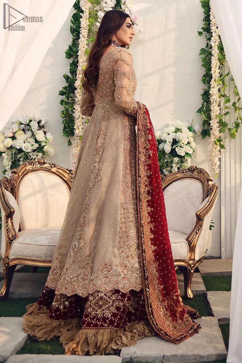 While the red dupatta with heavy work completely goes with fawn colour. This elegant ensemble turns a timeless piece into a chic fantasy. Nikah Wear - Red Lehenga - Fawn Front Open Pishwas.