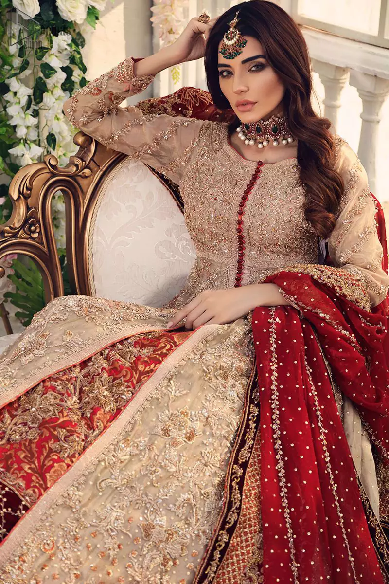 Gussy up the glamour with this intricately embroidered fawn ensemble. Fully embroidered bodice accentuated with floral motifs and finished with scalp borders. Look breathtakingly stylish in this Nikah wear embroidered fawn front open Pishwas. Pair it up with a red banarsi lehenga furnished with maroon velvet applique and frilled border. Nikah Wear - Red Lehenga - Fawn Front Open Pishwas.