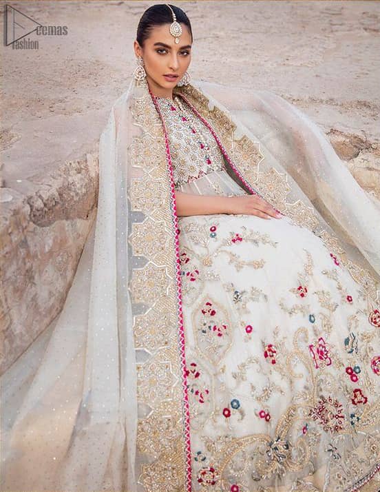 The new season is all about making a statement. It is an unforgettable look that will effortlessly take you from day to night this festive season. The bodice is fully embellished and the rest of the pishwas is ornamented with floral jaal with multiple color embroidery and thread work. The lehenga is more intensified with an embellished border with zardozi work on ivory canvas which instantly appeals to everyone’s attention. Dupatta is adorned with a delicate arrangement of hand-embellished geometric patterns with kora, dabka,sequins, pearls, crystal, and Swarovski all around the edges.