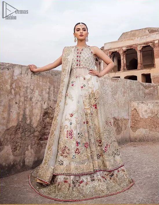 The new season is all about making a statement. It is an unforgettable look that will effortlessly take you from day to night this festive season. The bodice is fully embellished and the rest of the pishwas is ornamented with floral jaal with multiple color embroidery and thread work. The lehenga is more intensified with an embellished border with zardozi work on ivory canvas which instantly appeals to everyone’s attention. Dupatta is adorned with a delicate arrangement of hand-embellished geometric patterns with kora, dabka,sequins, pearls, crystal, and Swarovski all around the edges.