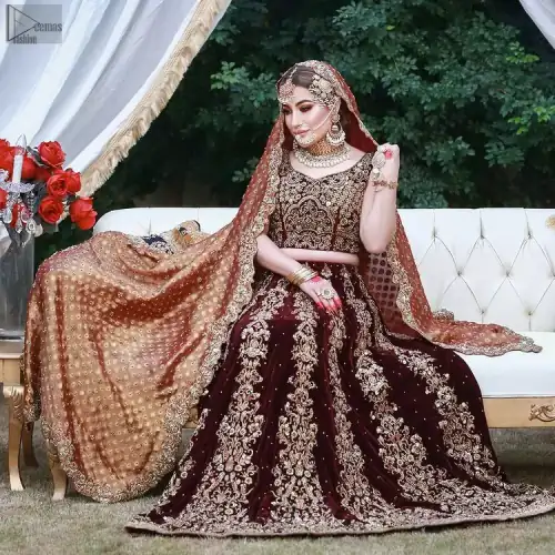 While an outstanding Maroon Velvet lehenga finalizes the overall dress, intensifying the sparkling copper embroidery over it.