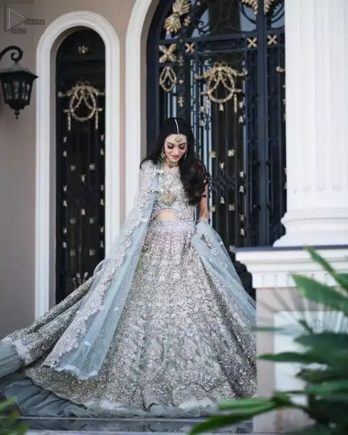 Nikah Wear - Pastel Blue Lehenga Blouse. This pastel blue sleeveless blouse is beautifully sculptured with floral embroidery, adorned with
