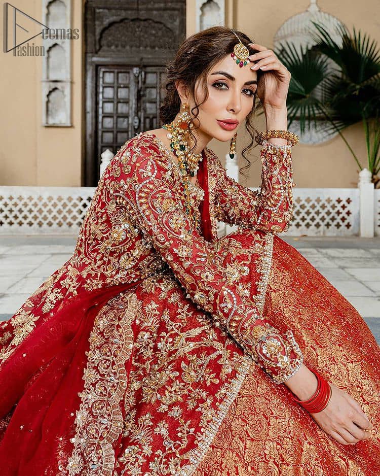 Red Bridal Peplum n Dupatta – Orange Lehenga. Red peplum with pure organza and fully engraved multi colour embroidery is such an eye-catching masterpiece that you would like to wear on your big day. Silver and golden combination of embellishment along with red pearls, Tilla Dabka, Appliques, Sequins and Zardozi work mainly gives such an eye feasting outfit to wear. The rounded, neckline and full sleeves give it a proper finishing in a beautiful attractive peplum style with Kattan Banarsi Jamawar exquisite Lehenga. With a concealed side zip closure along with floral motifs having finished edges. The Red organza dupatta has four-sided embellished borders.