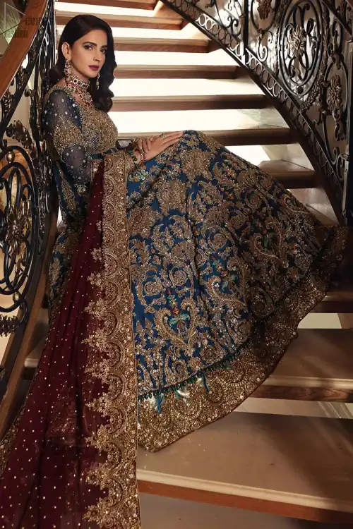 Style exquisitely with Teal Lehenga Pishwas on your Nikkah or Walima. The dress accompanies a fascinating Maroon dupatta.