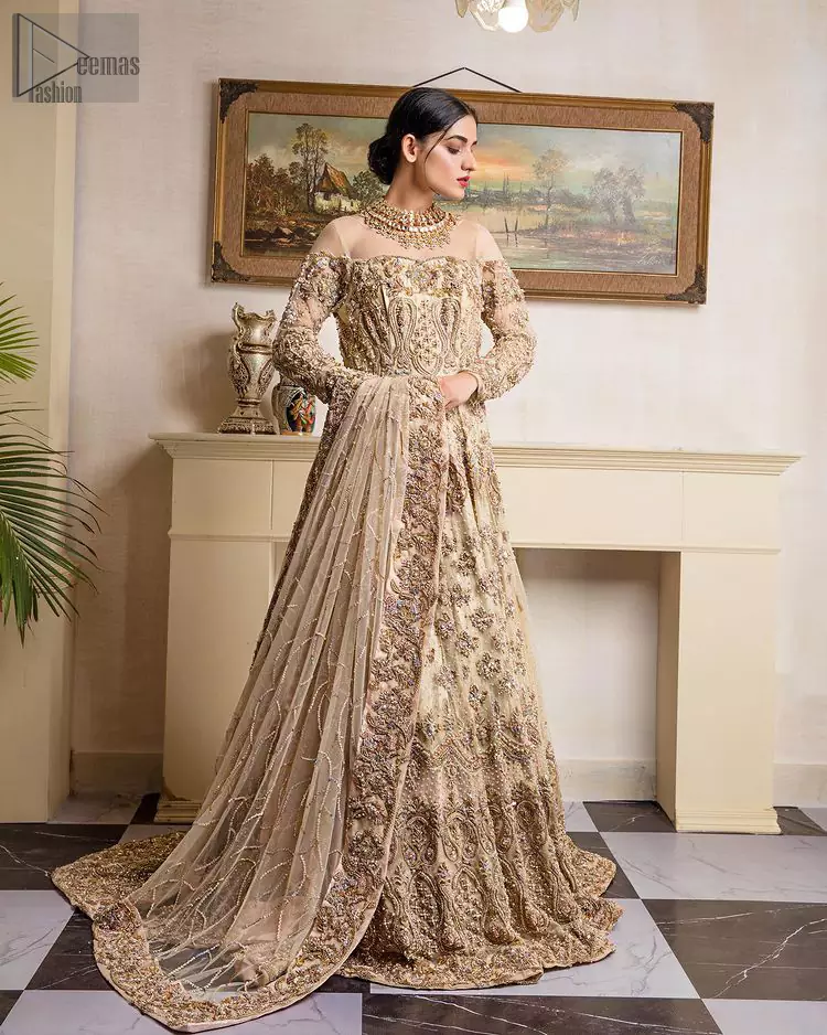 a charming full-sleeved bridal wear with a unique majestic illusion neck, making you the distinctive queen of the night. Decorated with floral motifs in a can-can style, a master artwork of multicolour embroidery enhances the magnificence of the attire.