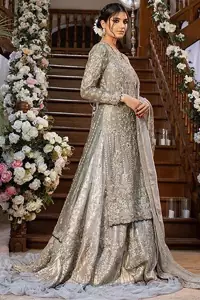 Gratifying yourself with the choice of the right dress is not always easy. But with a full-sleeved Gray Back Train Ruffled Lehenga Shirt, you would be more than pleased with your perfect decision. Marvellous back train, gorgeous round neckline, stunning frilled edges, outstanding geometric patterns and beautiful matching embellishment, this delightful Pakistani bridal wear is truly a progressive contribution to your decent personality. The dress code features a grey admirable shirt and dupatta made with pure organza, and a graceful lehenga made with katan banarsi jamawar. A concluding work of extreme exquisiteness in the shape of silver and gold embroidery over the Nikah dress, finally makes this attire ready to serve you with utmost satisfaction on your walima or nikah day.