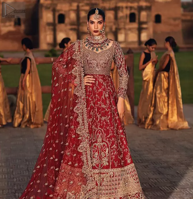 The maxi follows a graceful churidar pajama made with pure raw silk, with a red dupatta to complete your enchanting looks. This admirable dress is a treat to your reception day.
