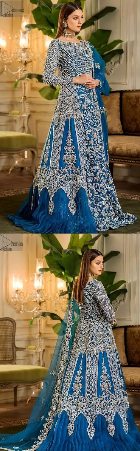 When it comes to the premium worthiness of bridal wear, the Royal Blue Blouse Lehenga takes the lead. A distinctive full-sleeved bridal wear featuring a boat-shaped neckline ensures all the eminence one would possibly desire on her big day. Its can-can style, ravishing traditional geometric patterns, and mesmerizing floral motifs speak for the attire’s dexterous craftsmanship. To intensify its supremacy, an elegant work of silver embroidery is styled with scrupulous attention to the minutest details. The choice of fabric is always made by paying special attention to the attire’s gracefulness, gorgeousness, comfort, and attraction. Henceforth, this marvellous attire with a heavy centre panel uses pure organza as its highly ravishing fabric, making the dress stunning for your Walima or Reception day.

