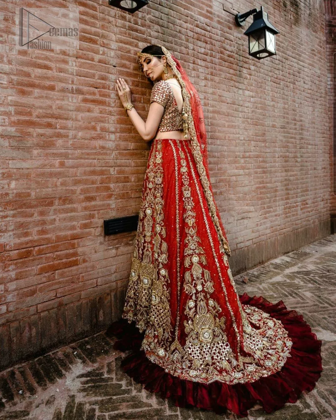 Red Ruffled Back Train Lehenga Blouse – Dupatta. It’s beautiful sweetheart neckline proceeds with mesmerizing Golden embroidery, all designed fantastically for your reception day.