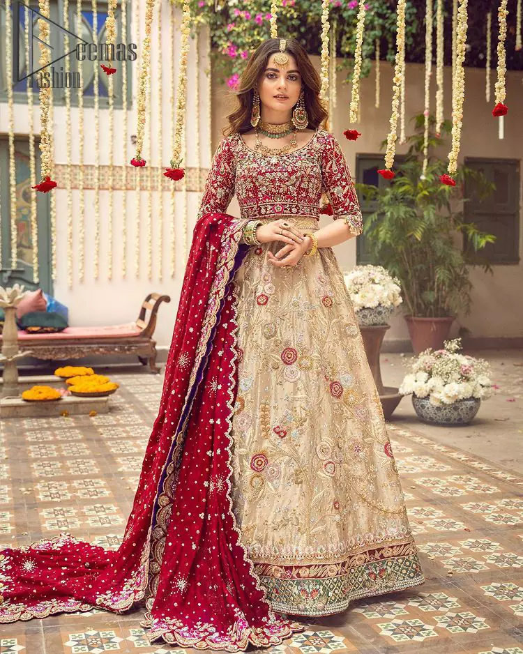 It's distinctive how the new-gen brides are welcoming red shades for their bridal outfits as well. So Welcome your guest to this charming beige lehenga. The three quarter-sleeved Red Blouse got it all for you. The bottom line of the blouse has separate portion embroidery that looks dazzled surprising. In addition to this, the Beige lehenga has embellished border embroidery and floral embroidery in dabka, kora work that gives the stunning look. The organza red dupatta that has a scalloped applique border all around the edges makes the look complete and comprehensive.