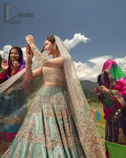 Talking about traditional, Deemas Fashion introduces the Aqua Lehenga and pink blouse which is an outstanding upgrade to bridal wear.