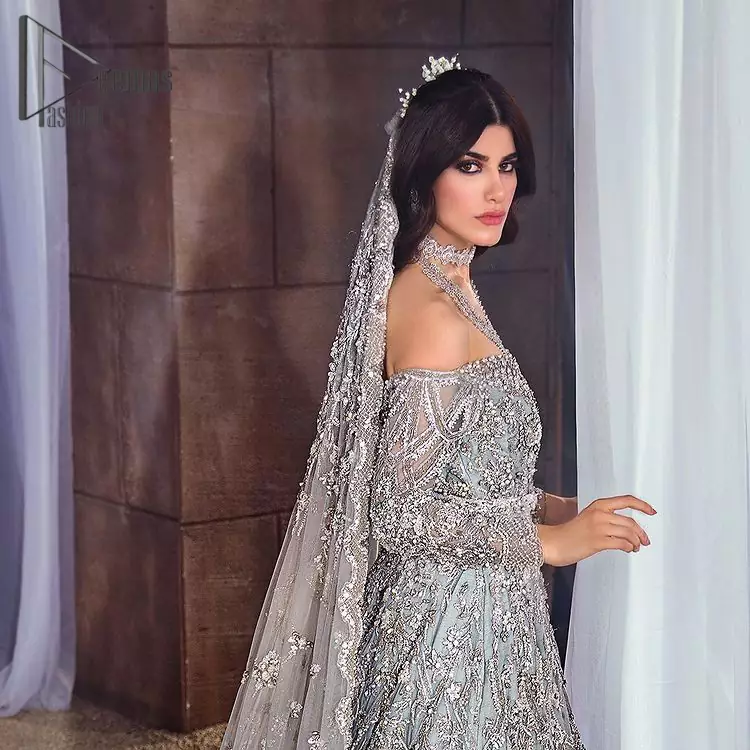 This fairy-tale ensemble is everything that you need to impress everyone at your  Walima ceremony. This off-shoulder frilled maxi is adorned with a fully embellished bodice, sleeves and fully embroidered daman is giving a perfect ending to this flare. The frilled maxi is adorned with a deep round neckline and comprises a pure D shape dupatta that looks super artistic look.