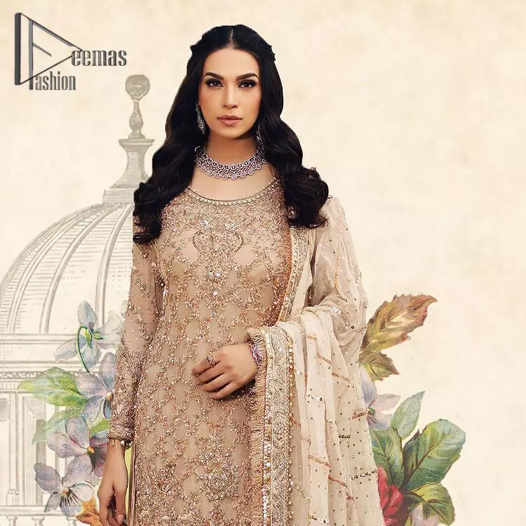 Opt for a versatile outfit for your Nikkah that is the perfect amalgamation of splendid colors, deluxe fabrication, and exquisite profile as well. Satiate your soul with extraordinary ensembles from this fawn long shirt gharara of DeemasFashion outfits. The round neckline of the long shirt is just amazing when combine with full sleeves. Further, it is highlighted with golden embroidery that includes tilla, kora, and dabka work. Pair up it with fawn gharara made with pure Katan banarsi jamawar fabric just to grant you a super aesthetic look. Complete this outfit with a fawn dupatta that is embellished with a four-sided Kiran and border as well.
