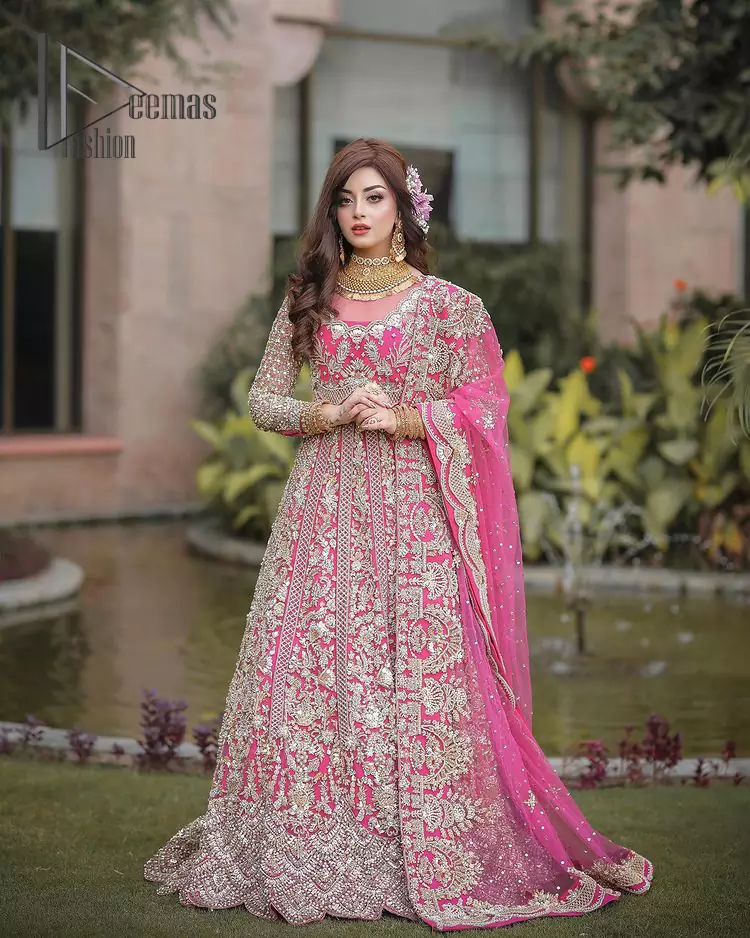 A color splash, a floral dream. Let your energy shine with this pink outfit. Make a dramatic entry with pink scalloped pishwas that's full sleeves look super-duper amazing when combine with Jewel neckline. It is streaking with the finest silver embroidery that count in tilla, kora, dabka, and crystal work to give you enthusiast look. Further, this scalloped pishwas is coordinated with Pink dupatta that is adorned with four sided borders and sequins spray all over to give you shiny energy on any party.