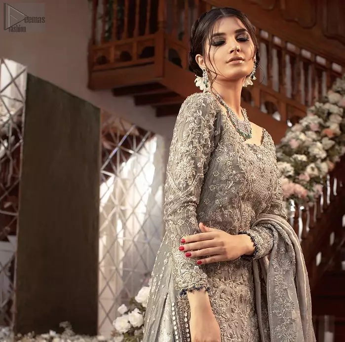 Gratifying yourself with the choice of the right dress is not always easy. But with a full-sleeved Gray Back Train Ruffled Lehenga Shirt, you would be more than pleased with your perfect decision. Marvellous back train, gorgeous round neckline, stunning frilled edges, outstanding geometric patterns and beautiful matching embellishment, this delightful bridal wear is truly a progressive contribution to your decent personality. The dress code features a grey admirable shirt and dupatta made with pure organza, and a graceful lehenga made with katan banarsi jamawar. A concluding work of extreme exquisiteness in the shape of silver and gold embroidery over the dress, finally makes this attire ready to serve you with utmost satisfaction on your walima or nikkah day.