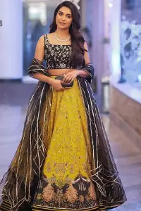 You smelled like sunshine and daisies when this pure magic wrapped around as our embroidery is luxurious. Yellow and black is the super trend of mehndi occasions. This eye-catching sleeveless black blouse having boat shape neckline looks priceless in silver and golden embroidery. In addition to this, yellow lehenga embellished with kora, dabka and sequins work and beautifully designed borders with zardozi, applique and Kiran shows the feeling of mehndi bride. Pair it up with a black dupatta that you would definitely want to wear for your next event.