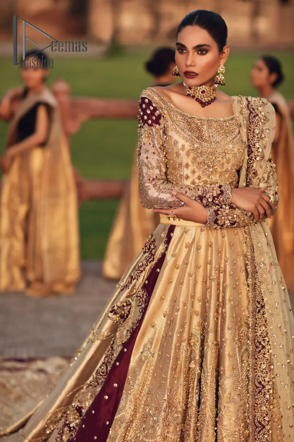 Adorn yourself in the layers of golden that feel rich on the skin. This outfit which is starting with a blouse beautifully laden with golden embroidery that includes kora, dabka, tilla to give you a traditional bride look. It is highlighted with boat shape neckline and super aesthetic full-sleeves to enhance your emotion of you on your Big Day. It is systematically arranged with a two-tone lehenga which is prominent with back train style and heavily adorned with embroidery. Finish this article with a golden scalloped dupatta that is embellished with four-sided borders and sequins sprayed all over. 