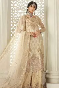 Pure bliss is seeing a bride smiling ear to ear through her whole wedding. Just go with a retro vibe on your Nikkah, everyone calls you super queen. This ivory long shirt is pleasingly furnished with golden and antique embroidery that includes kora, dabka, tilla, and crystal work. The inner blouse is intensified with a square neckline just to give you a super surprising look. It is systemized with ivory sharara that border is embellished with beautiful embroidery as well. Complete this amazing look with a dupatta which is adorned with a four-sided handsome border and sequins spray all over with so much love.