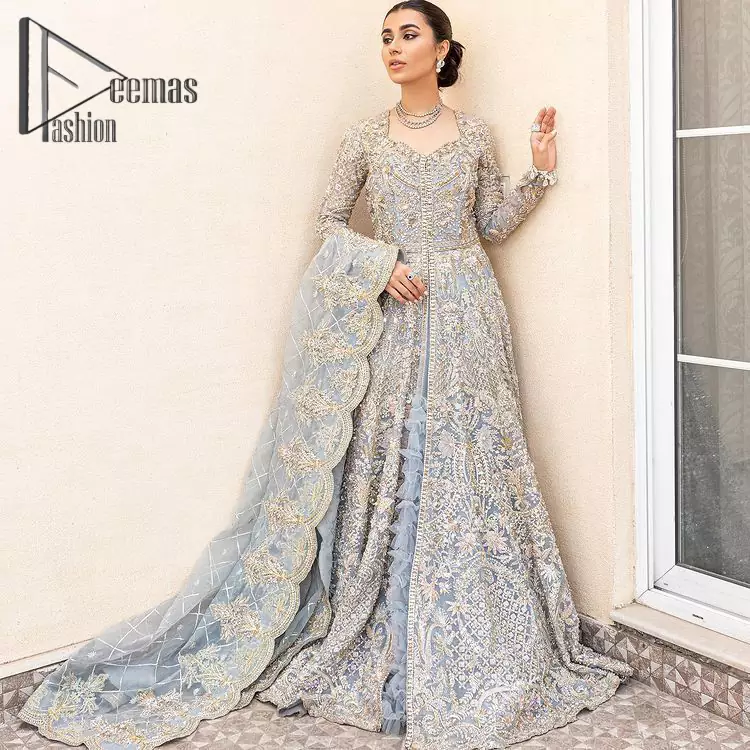 Something to blue about!. Trust on DeemasFashion to bring the magic of light blue colour for you on your walima day. Starting this outfit with a light blue front open maxi which is appealing with silver embroidery. The embroidery is further prominent with tilla, kora, zardozi and pearls work to raise the loveliness of the outfit. It is paired up with a full frilled lehenga that is designed just to express the feelings of a dreamy fairy on your Walima day. Complete this light blue outfit with the same colour scallop[ed dupatta that is adorned with a four-sided embellished border and sequins spray all over. 
