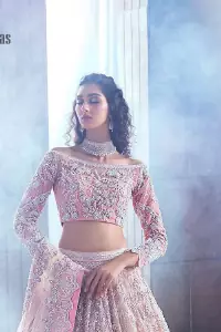 Deemas Fashion just defines sophistication and minimal high fashion in terms you desire. Reveal your aura in this tea pink off-shoulder blouse that is beautifully decorated with silver embroidery that involves a kora, dabka, tilla, and crystal look just to grant you mesmerizing look. Further, the full sleeves of the blouse look so admiring on your walima day. It is arranged with a frilled lehenga again which is ornamented with heavy silver embroidery so that you can steal everyone's heart. Finish this article with a tea pink dupatta that is prominent with four-sided border embellishment.