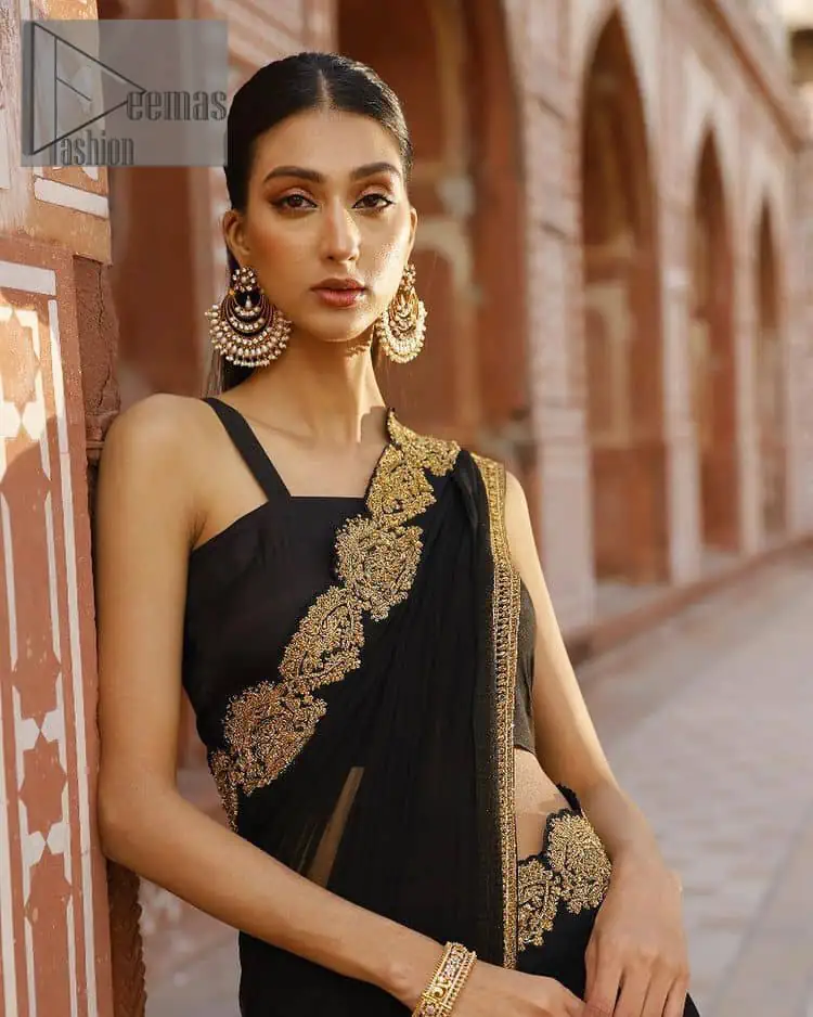 Every saree tells a story! Black is always the reason behind any smile at parties. DeemasFashion also presents a formal saree in black that you can wear at any function or party. The black blouse having sleeveless and strap neckline gives you so soothing and romantic look. Further, the simplicity of the blouse enhances the beauty of the outfit. It comes with a pure black saree which is ornamented with golden embroidery. It is highlighted with tilla, kora, and dabka work on borders. The pallu of the saree is also prominent with golden embridery.
