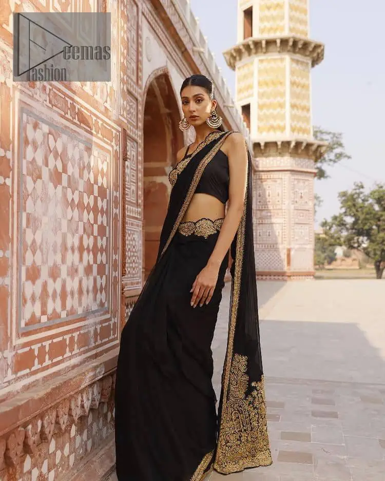 Every saree tells a story! Black is always the reason behind any smile at parties. DeemasFashion also presents a formal saree in black that you can wear at any function or party. The black blouse having sleeveless and strap neckline gives you so soothing and romantic look. Further, the simplicity of the blouse enhances the beauty of the outfit. It comes with a pure black saree which is ornamented with golden embroidery. It is highlighted with tilla, kora, and dabka work on borders. The pallu of the saree is also prominent with golden embridery.