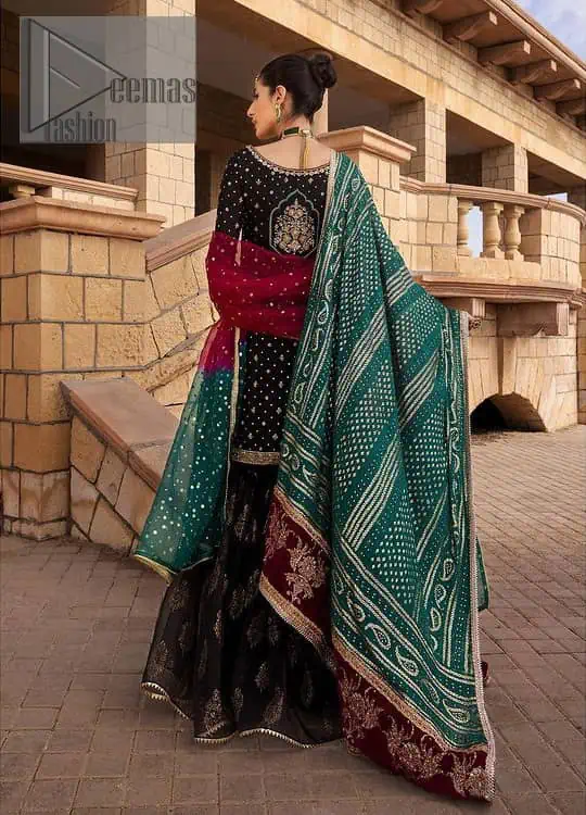 The perfect combination of crazy black with ever so classic green. Stunningly embrace you with a black shirt which is beautifully decorated with golden embroidery so you can wear it at any night and day dazzling event. It involves kora, dabka and Kundan work to escalate the beauty of the outfit. Further, the boat shape neckline amplifies the point of view when together with full sleeves. It is coordinated with black gharara that is enhanced with floral motifs all over. Finish this article with a green dupatta that is adorned with sequins sprayed all over. You can also carry a chaddar of green colour with this outfit.