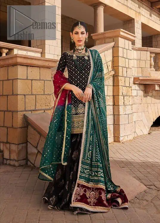 The perfect combination of crazy black with ever so classic green. Stunningly embrace you with a black shirt which is beautifully decorated with golden embroidery so you can wear it at any night and day dazzling event. It involves kora, dabka and Kundan work to escalate the beauty of the outfit. Further, the boat shape neckline amplifies the point of view when together with full sleeves. It is coordinated with black gharara that is enhanced with floral motifs all over. Finish this article with a green dupatta that is adorned with sequins sprayed all over. You can also carry a chaddar of green colour with this outfit.